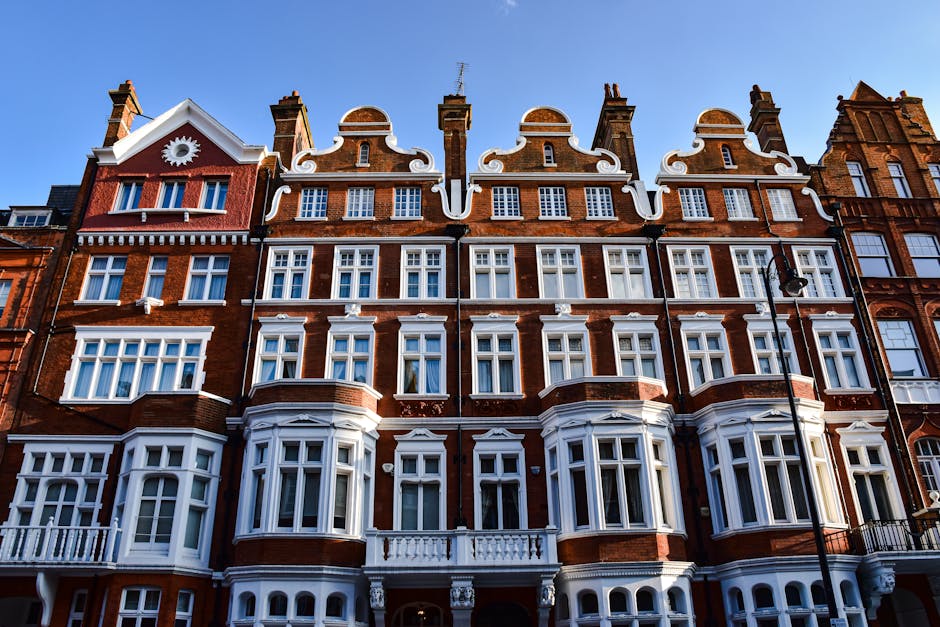 Victorian-style red brick building in London with ornate windows and detailed facade.
